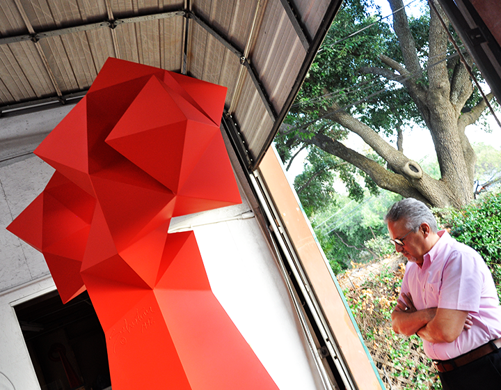 UTSA Libraries Art Collection curator Arturo Infante Almeida looks over one of the largest of Sebastian’s pieces to be relocated to Main Campus