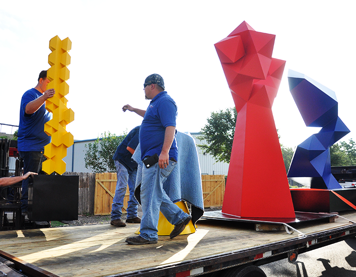 Loading the sculptures on a flatbed truck to be moved to UTSA’s campuses