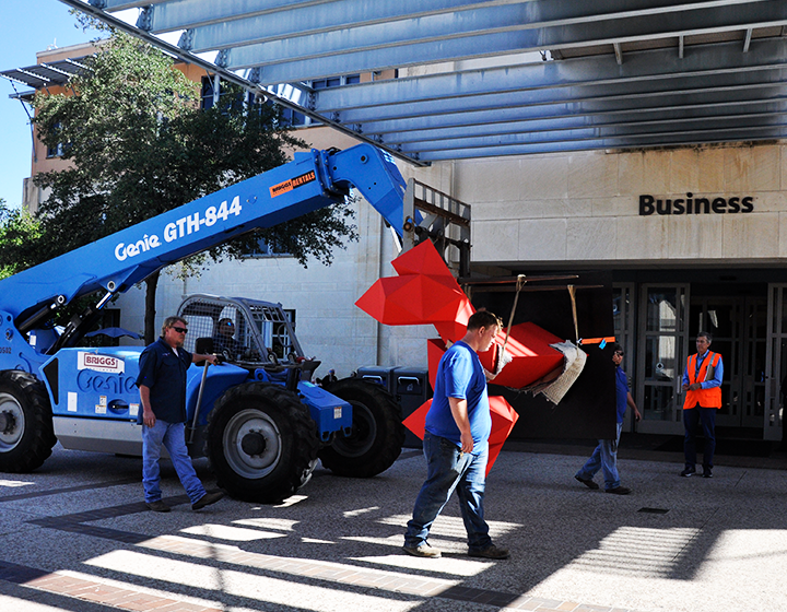 A Sebastian sculpture is transported across Paseo del Norte to the JPL