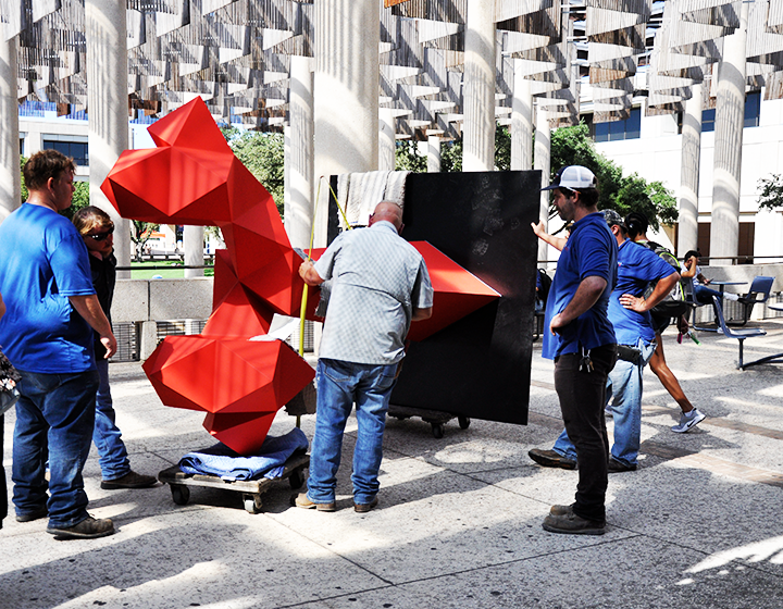 A Sebastian sculpture is transported through Sombrilla Plaza