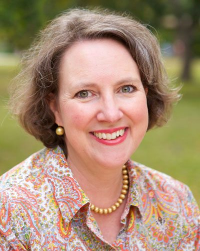 Headshot of Martha Smith smiling, wearing a paisley blouse